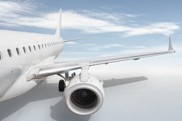 Obraz premium White passenger airplane isolated on bright background with sky. View of the wing and rear aircraft