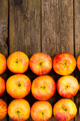 apple fruits in a row, old weathered wood table background