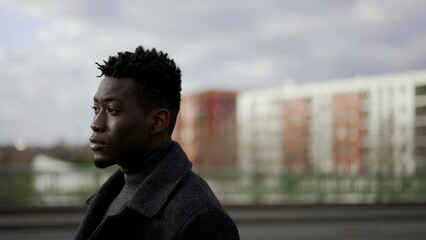 Pensive black African man walking in city outdoors. elegant person