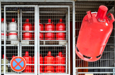Gas crisis. Gas cylinders stored in a cage. Gas cylinders locked behind grid