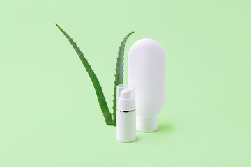 Blank cosmetics tube and dispenser with aloe vera on background.Organic cosmetic concept.