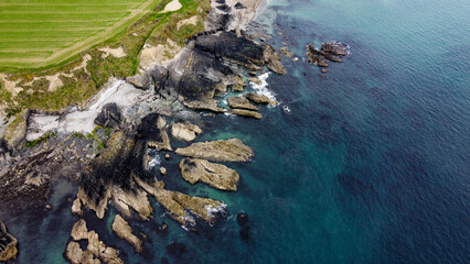 Rocks on the Irish littoral, top view. The shore of the Atlantic Ocean. kind of Northern Europe. Rocky coastline. Aerial photo. Drone point of view.