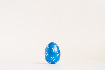 Easter blue egg with with floral pattern isolated on white background. Minimal easter concept. Happy Easter card with copy space for text Top view, flatlay