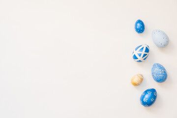 Blue Easter decorated eggs isolated on white background. Minimal easter concept. Happy Easter card with copy space for text. Top view, flatlay.