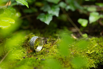 silver ring in a green nature setting