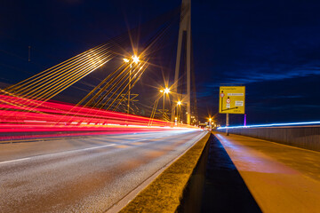 Fototapeta na wymiar Traffic motion lights on a bridge during night