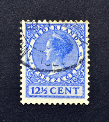 Cancelled postage stamp printed by Netherlands, that shows portrait of queen Wilhelmina, circa 1925.