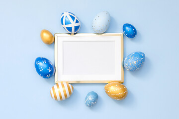 Frame with gold decorated easter eggs with copy space for text on blue background. Minimal Happy Easter concept. Top view, flatlay