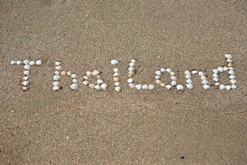 Fototapeta na wymiar word Thailand written on the sand