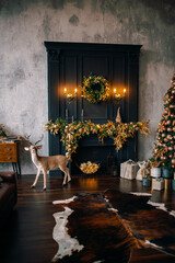 Interior of a room decorated with Christmas and New Year. A festively decorated room in black shades with a beautiful fireplace and a garland.