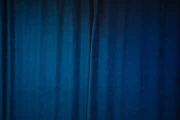 Blue colored drape curtain hanging on window in bedroom interior. Background of textured fabric cloth. - Powered by Adobe