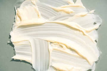Silky cream texture over olive background with copy space. Olive cream smears. Skincare product