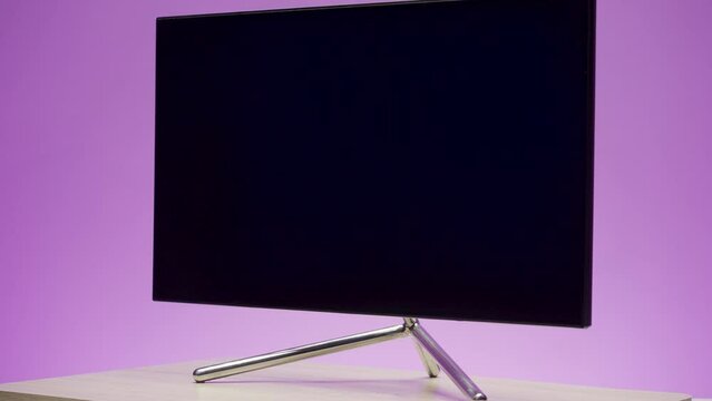Large plasma TV. Action. A blue background with a changing color with a new generation TV that is shot from all angles.