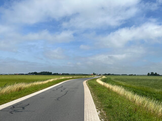 Road through farmland around Tzum