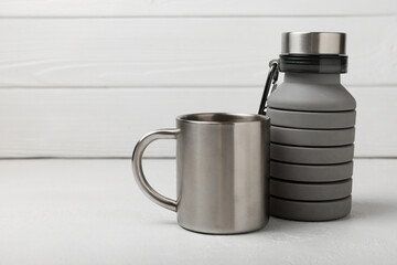 Set of tourist equipment on a textured background. EDC set. Flat layout. Thermos and travel mug for water. Travel set.