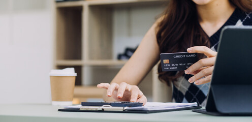Woman hand using smart phone and laptop in outdoor nature park and sunset sky with bokeh light abstract background. Technology business and freelance working concept. Vintage tone filter color style.