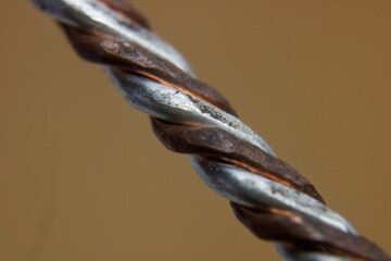 Closeup of copper wire texture on brown background