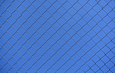 blue sky through a metal lattice. background. ecology concept