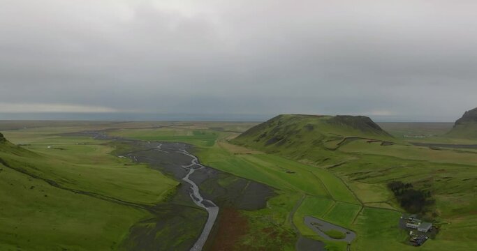 aerial view Seljavallalaug green valley with river, scenic icelandic lanscape with green mountains