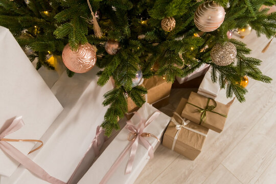 Craft gifts under the tree. The concept of Christmas and New Year.Christmas mood. Celebrating of New Year.Many boxes of Christmas gifts in eco-friendly craft paper packaging