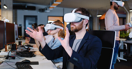 Male in headset having virtual reality experience. Moving hands in air. Futuristic. Augmented. Robot on the background. Android. Humanoid