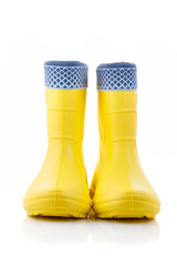 Yellow rubber boots isolated on white background. Kids shoes. Full depth of field. Close-up