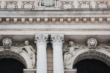 Two sculptures of muses allegory of arts and a lion on the facade of the Opera and Ballet Theater in Lvov. Neo-Renaissance in architecture.