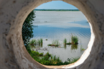 Obraz na płótnie Canvas View of Lake Nero through a window in the monastery wall, Rostov.