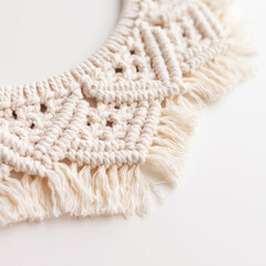 Macrame wreath on a white background close up. Natural cotton thread. Eco home decor. Copy space