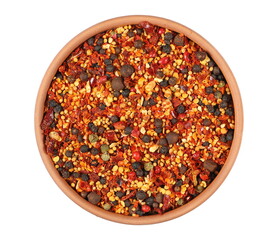 Spicy mixture of spices with chopped lemon peel, chili, peppercorns (black, green and red), mustard seeds, allspice, chopped ginger in clay pot isolated on white, top view