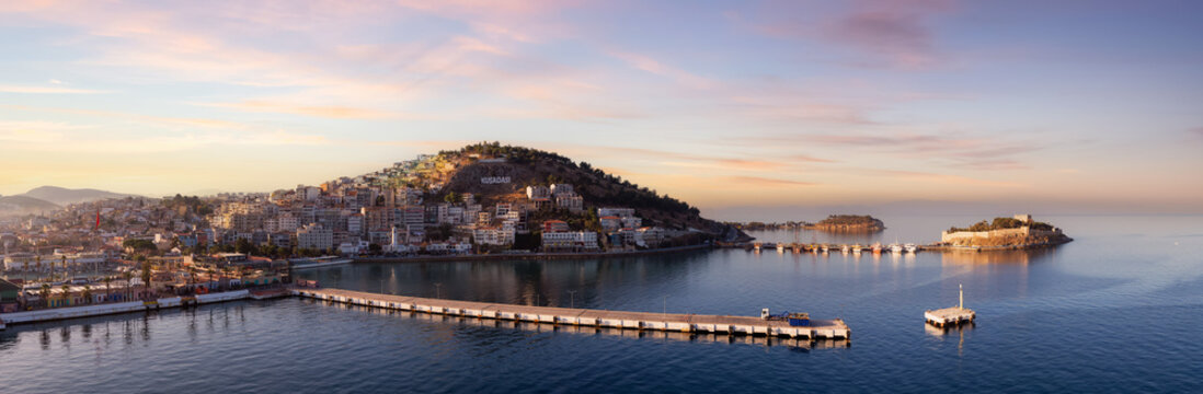 Homes and Buildings in a Touristic Town by the Aegean Sea. Kusadasi, Turkey. Colorful Sunrise Art Render. Panoramic Aerial View from Cruise Ship