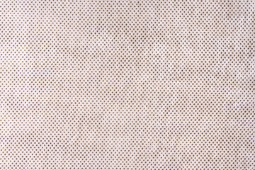 Texture background of velours beige fabric with dots pattern. Fabric texture of upholstery...