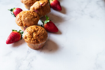 Strawberry muffins on a white marble background. Top view and copy space. - 548052625