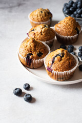 Blueberry muffins  served on a white plate on a marble background. - 548052654