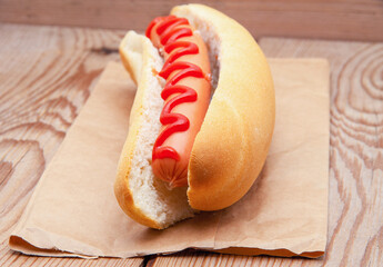 Tasty hot dog on wooden table