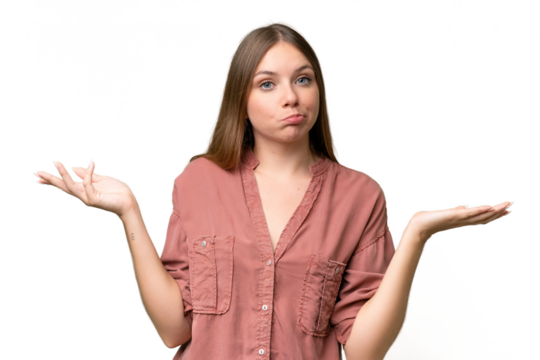 Young beautiful blonde woman over isolated background having doubts while raising hands