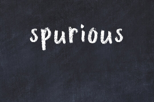 Black chalkboard with inscription spurious on in