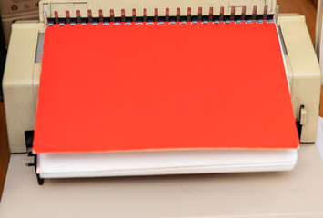 A manual perfobinder for stitching documents with a plastic spring. A device for binding documents.