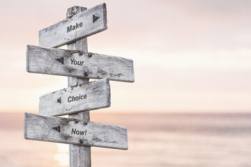make your choice now text written on wooden signpost outdoors at the beach during sunset