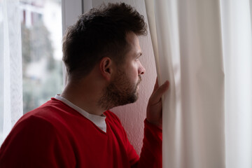 Caucasian man peeking through window being shocked with accident on street