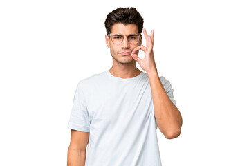 Fototapeta premium Young caucasian handsome man over isolated background showing a sign of silence gesture