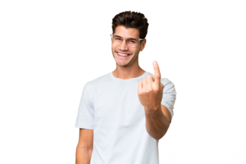 Young caucasian handsome man over isolated background doing coming gesture