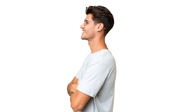 Young caucasian handsome man over isolated background in lateral position