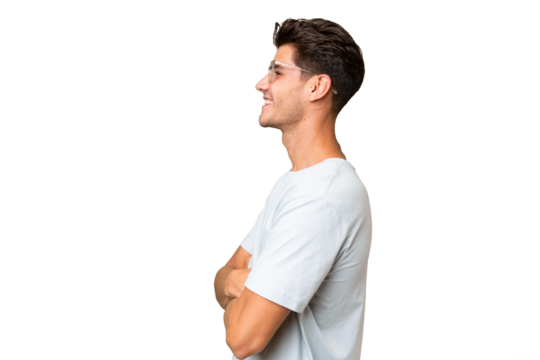 Young caucasian handsome man over isolated background in lateral position