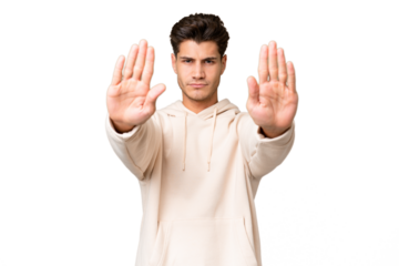 Young caucasian handsome man over isolated background making stop gesture and disappointed