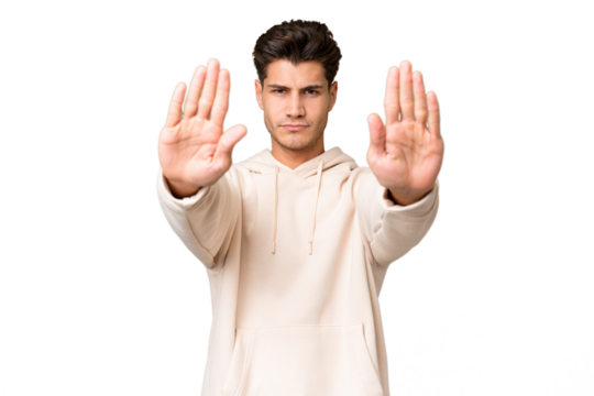 Young caucasian handsome man over isolated background making stop gesture and disappointed