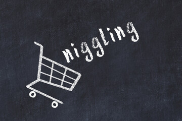 Chalk drawing of shopping cart and word niggling on black chalboard. Concept of globalization and mass consuming