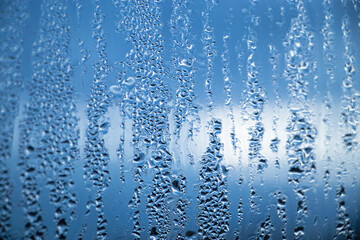 Naklejka na ściany i meble Texture of misted glass in autumn. Drops of water on window in rainy weather.