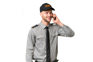 Young security caucasian man over isolated background keeping a conversation with the mobile phone