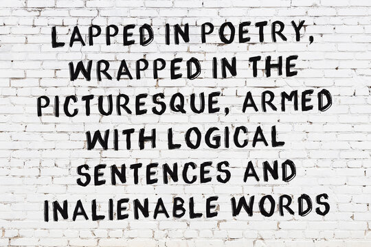 Black painted inscription of smart quote on white brick wall